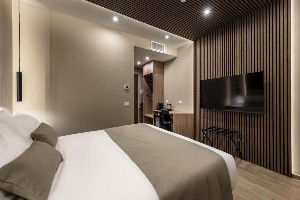 Villafranca suite with a double bed and wood panelling